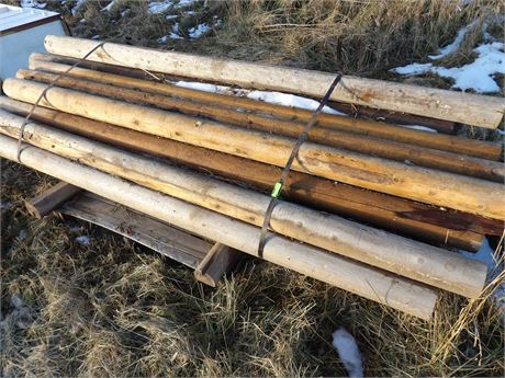LARGE PILE OF WOOD POSTS